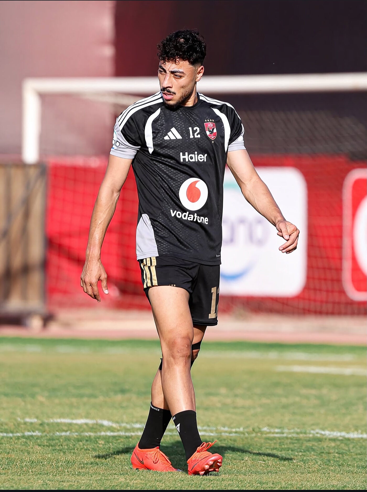 Professional footballer in training in black Seven performance socks