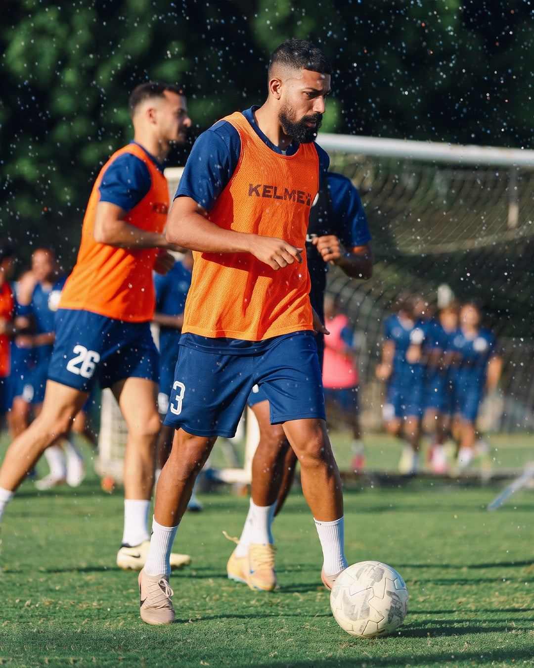 Professional footballers in a training drill wearing white Seven performance socks
