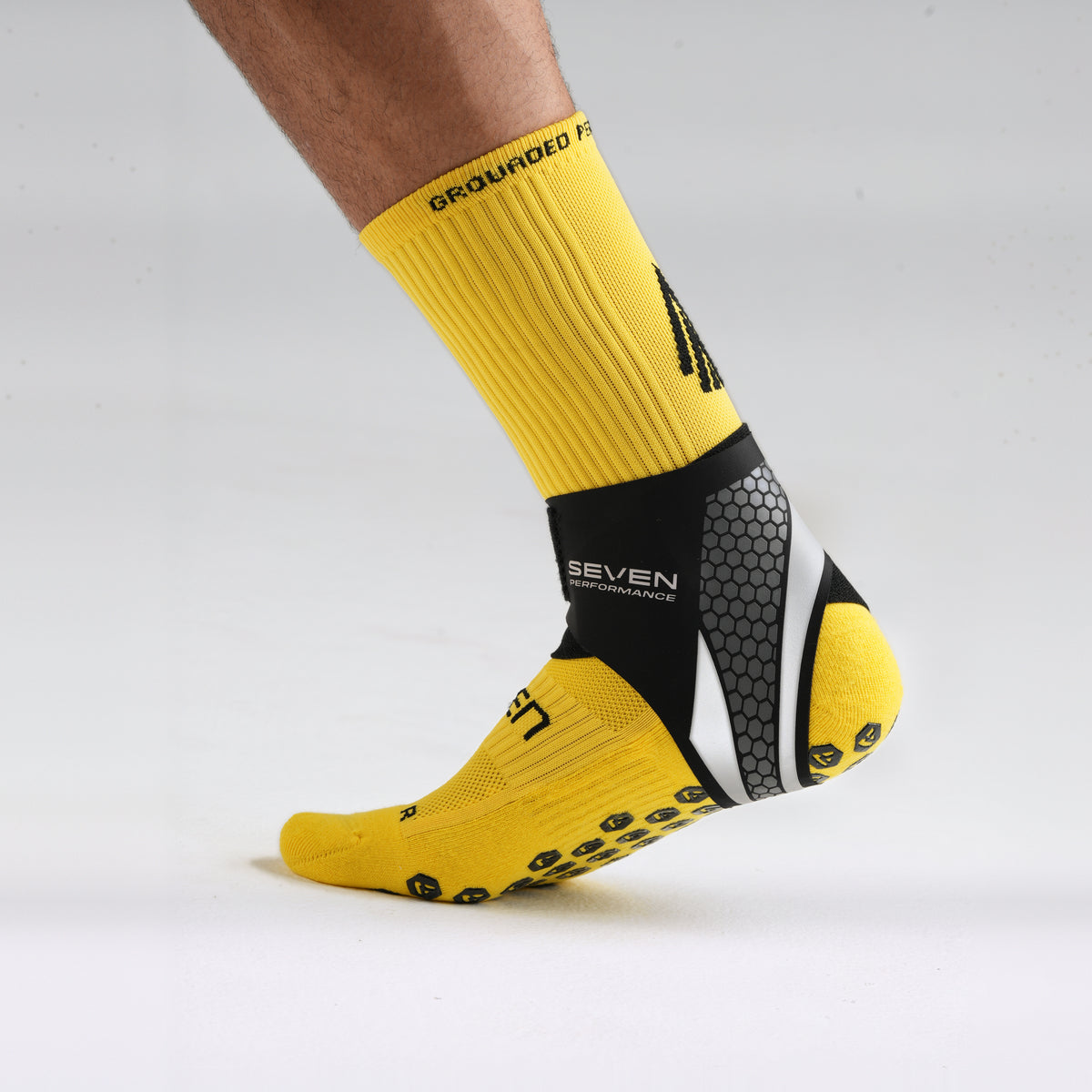 Seven Ankle Support worn over a yellow performance sock, outer profile