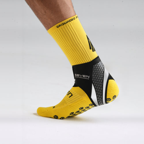 Seven Ankle Support worn over a yellow performance sock, outer profile
