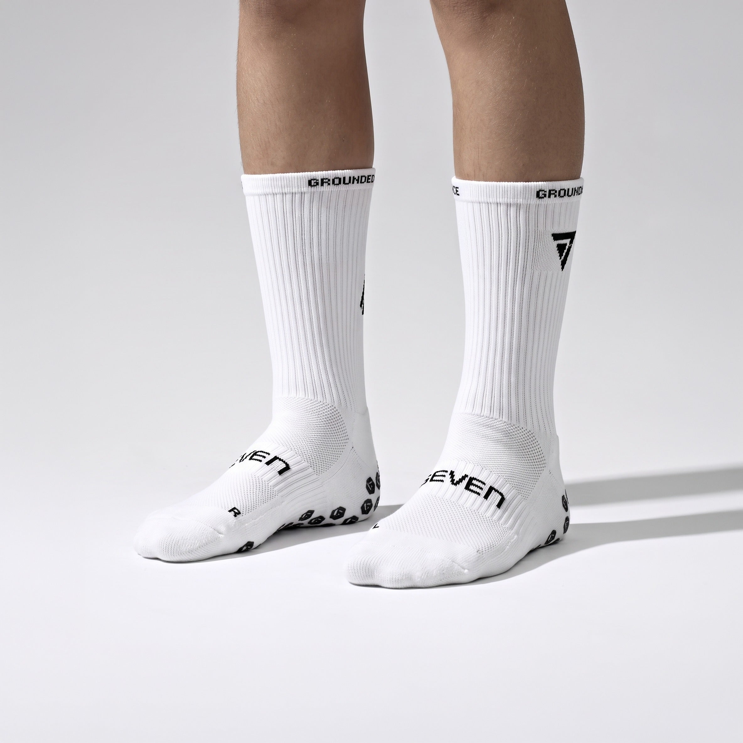 Seven junior white grip performance socks, front view on junior model