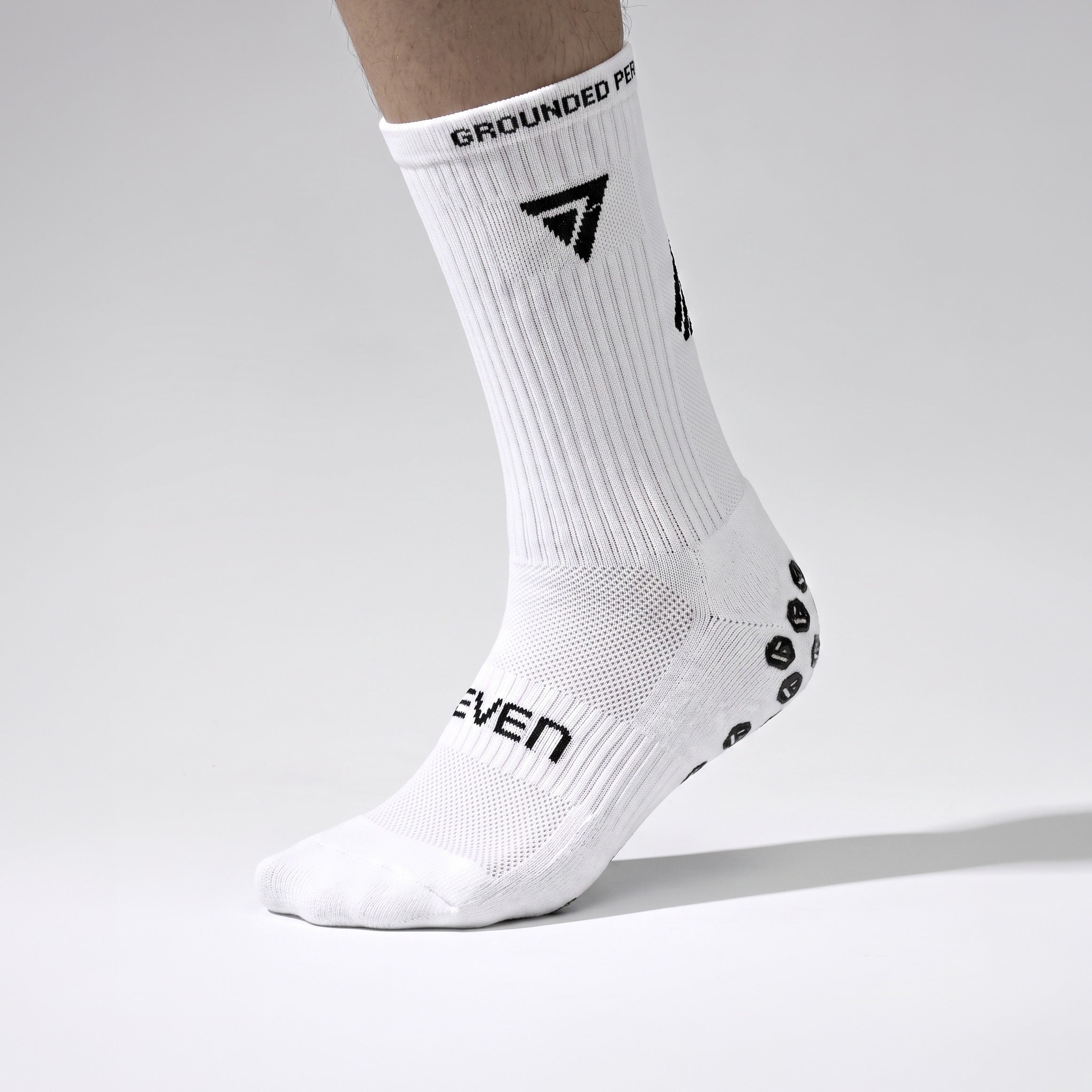 Seven junior white grip performance socks, inner side close view with grip sole